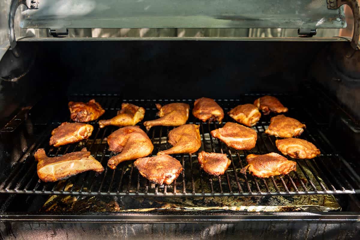 Chicken pieces on a Traeger pellet grill smoker.