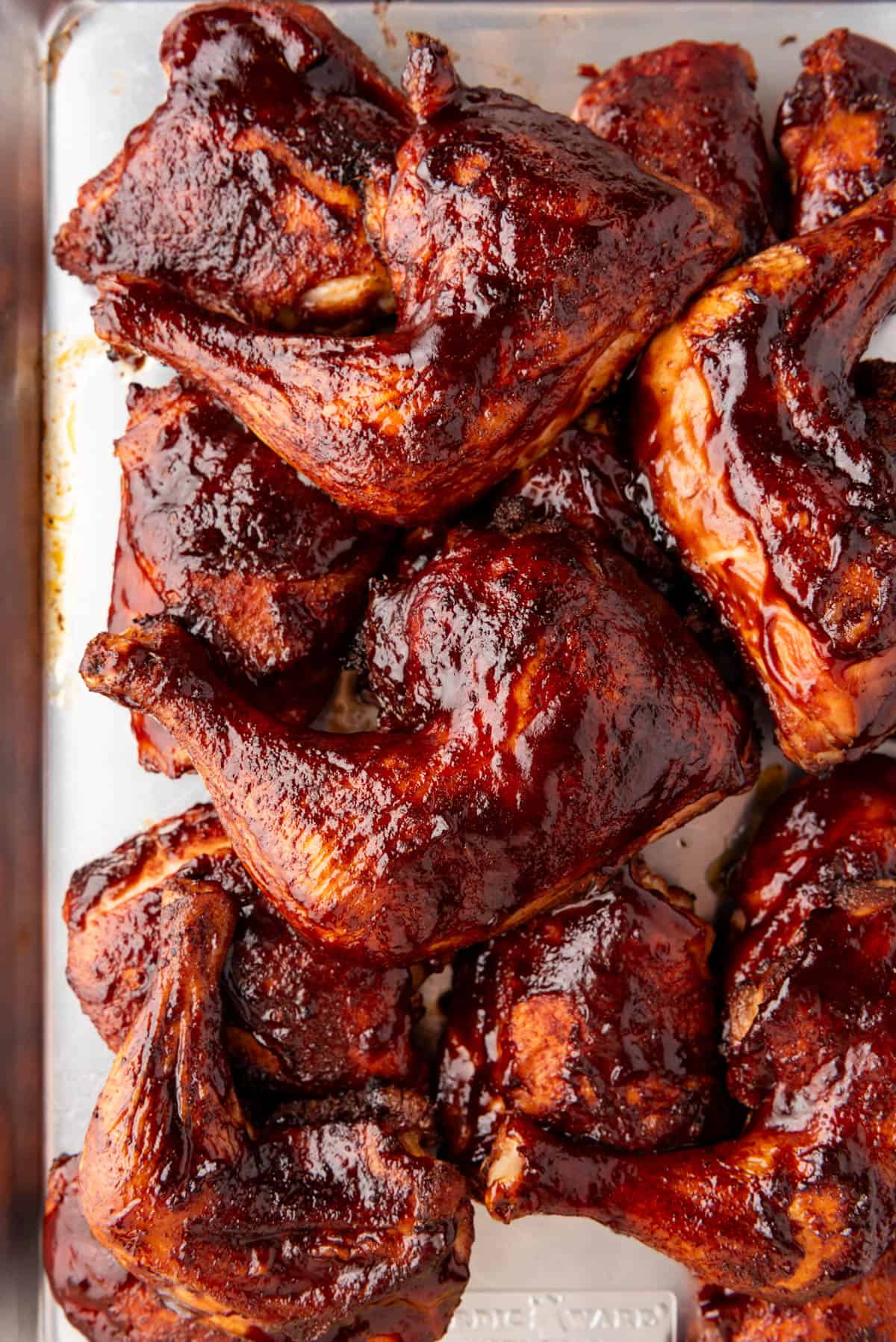 An image of smoked chicken thighs on a baking sheet.