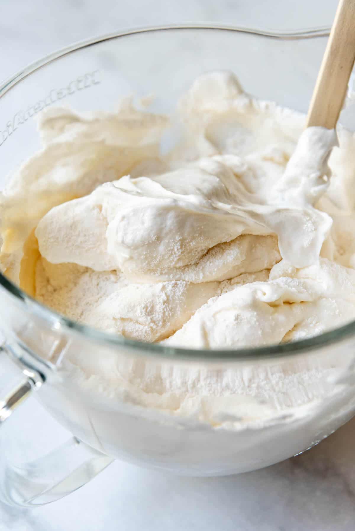 Folding dry ingredients into stiff egg whites.