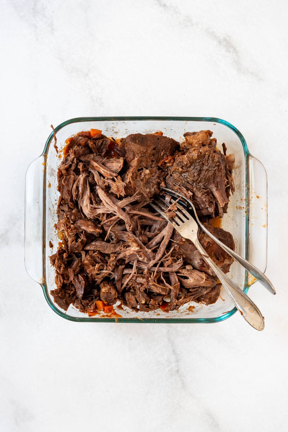 Shredding beef to make beef ragu.