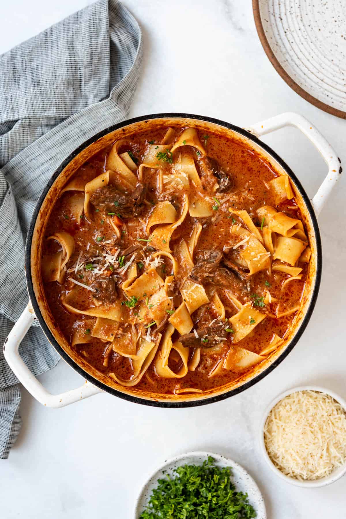 A finished pot of beef ragu with pappardelle.