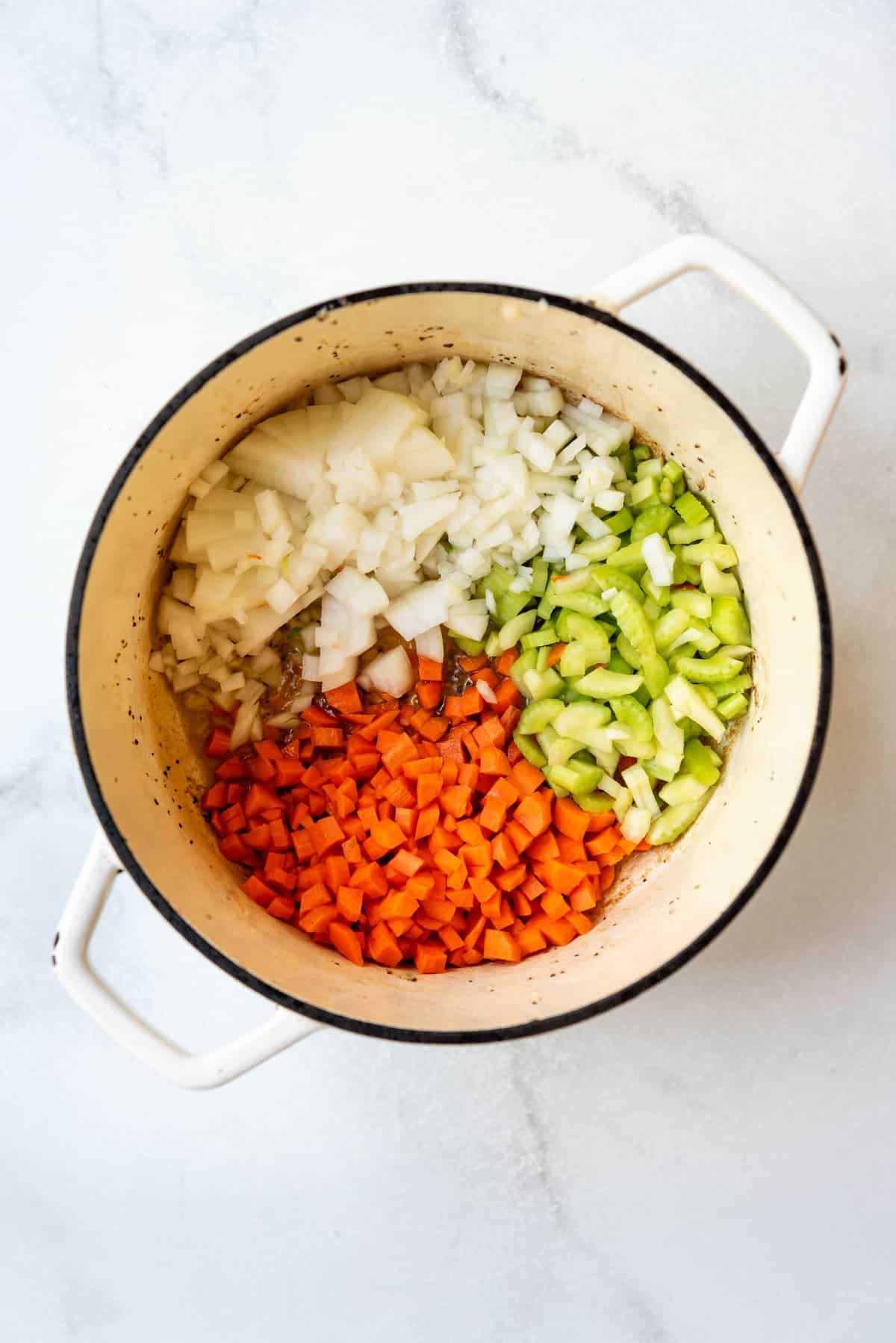 Diced onion, carrot, and celery to a dutch oven.