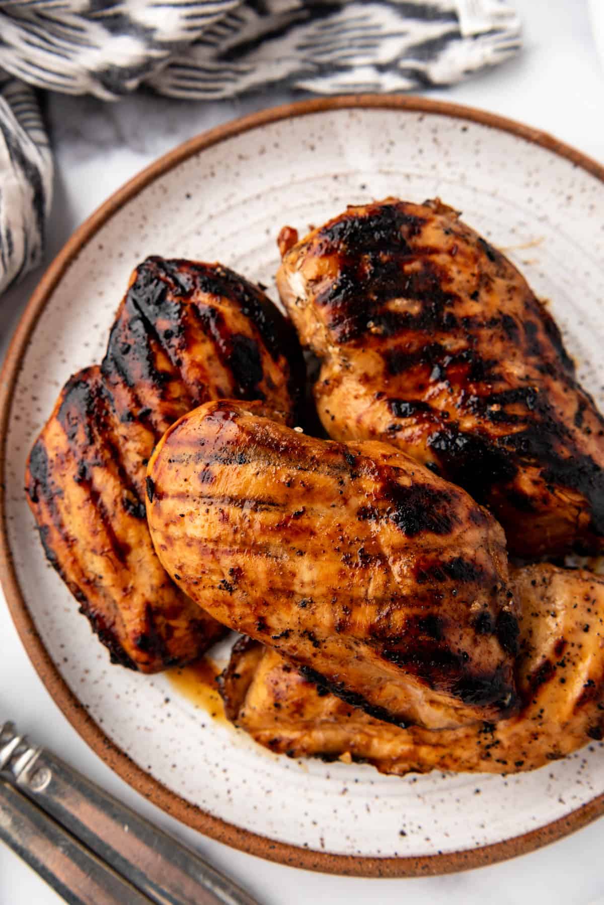 An overhead image of grilled chicken breasts on a plate.