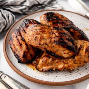 An image of grilled marinated chicken breasts on a plate.