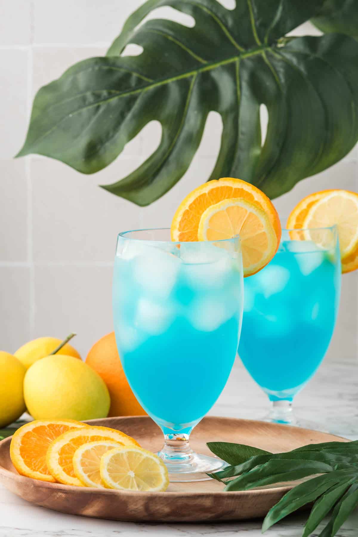 Mocktail glasses filled with a non-alcoholic blue drink.