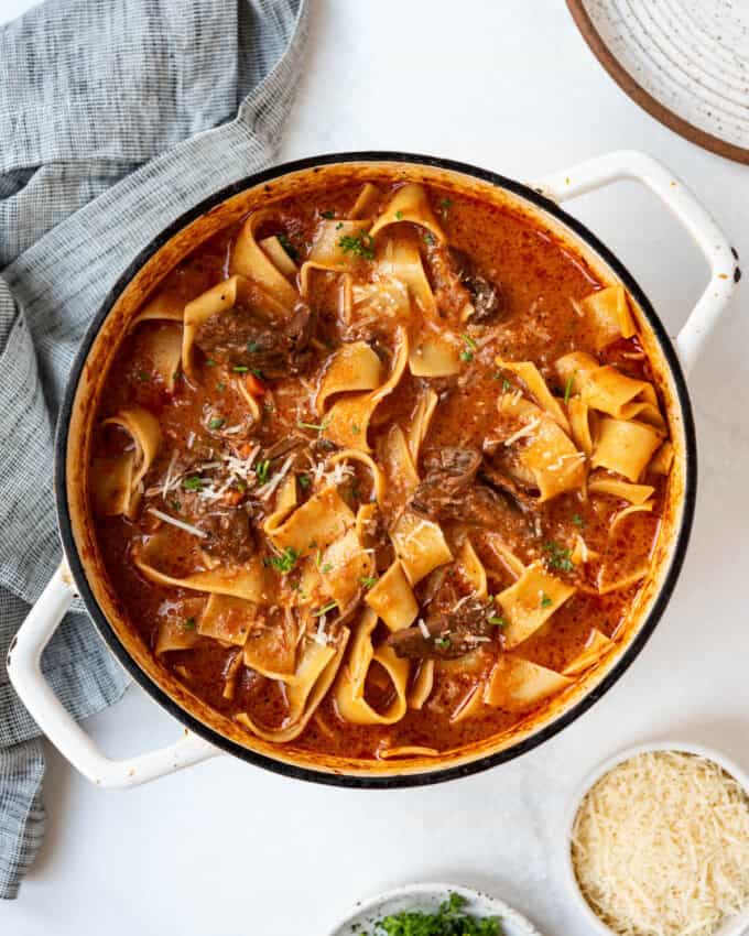 A finished pot of beef ragu with pappardelle.