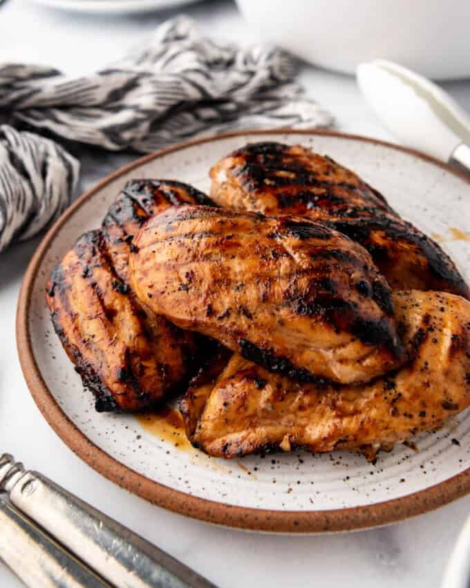 An image of grilled marinated chicken breasts on a plate.