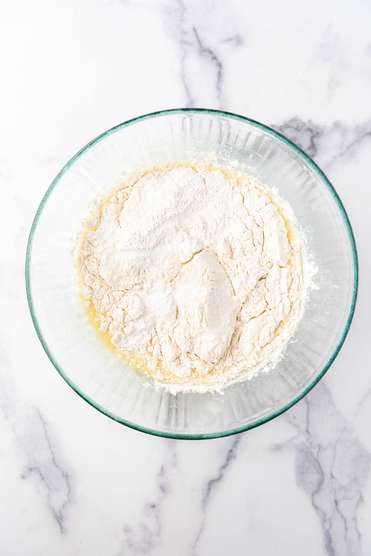 Adding dry ingredients to make rhubarb quick bread.