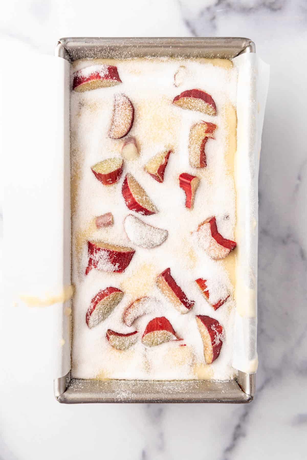 Rhubarb quick bread batter in a loaf pan.