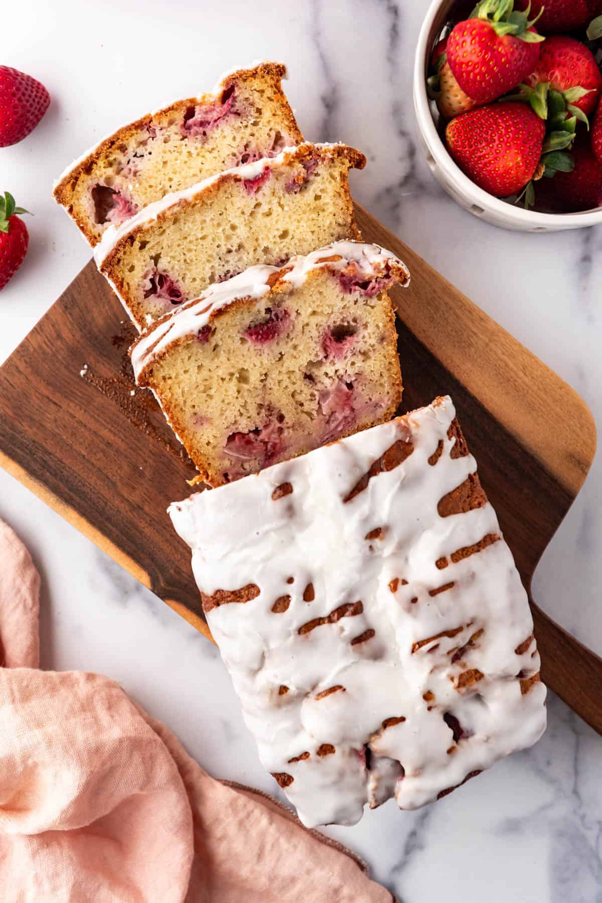 An overhead image of a loaf of glazed strawberry bread.