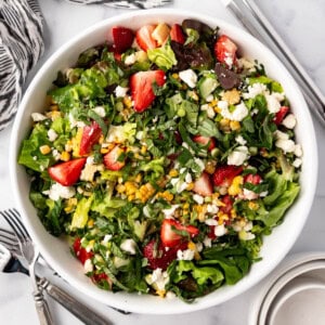 An overhead image of a large serving bowl of strawberry corn summer salad.