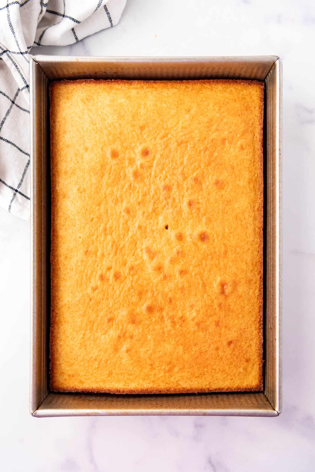 A baked sheet cake in a pan.