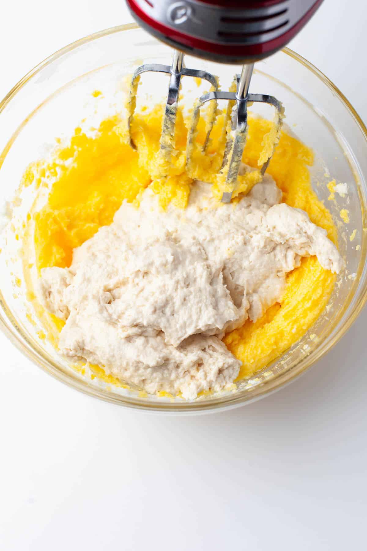 Overhead image of egg mixture and flour mixture being mixed together.