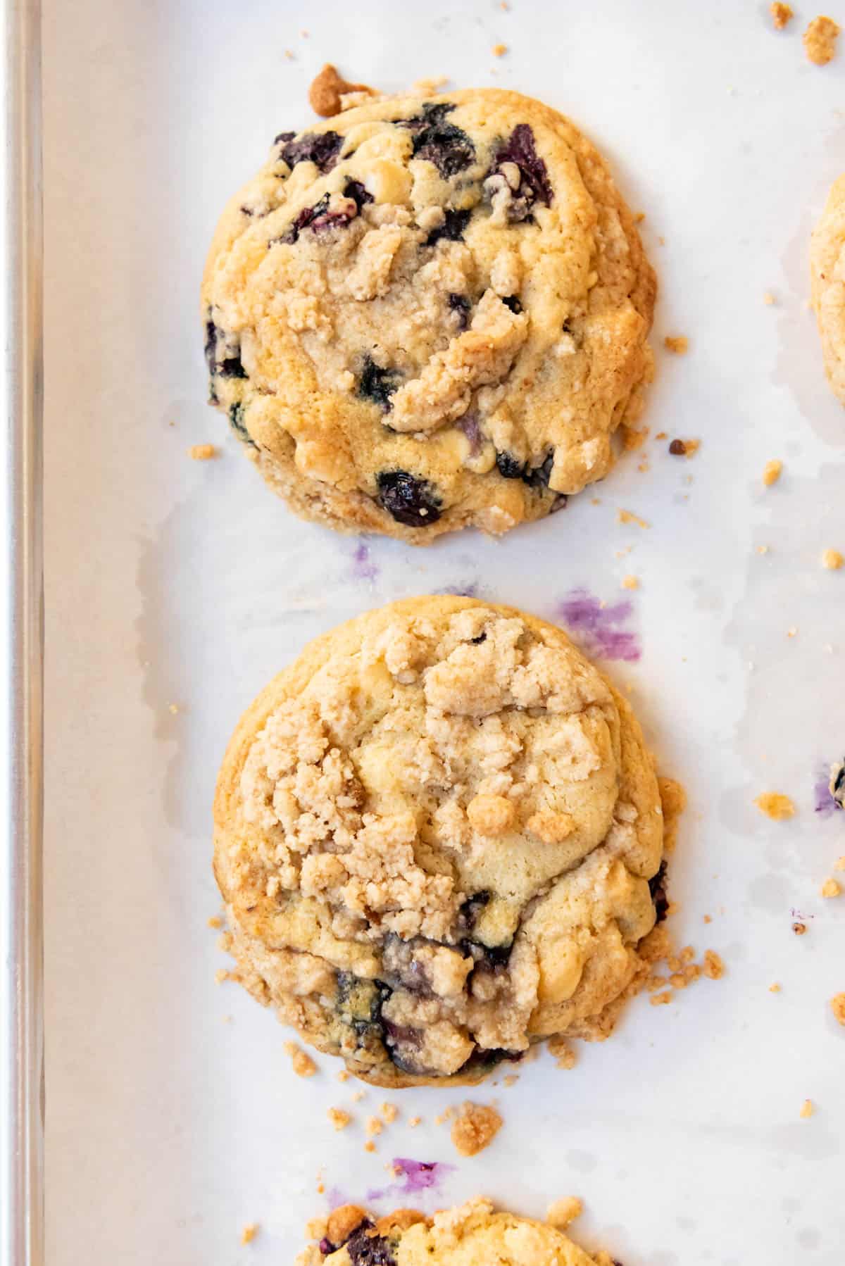 An overhead image of two blueberry muffin cookies with crumb topping.