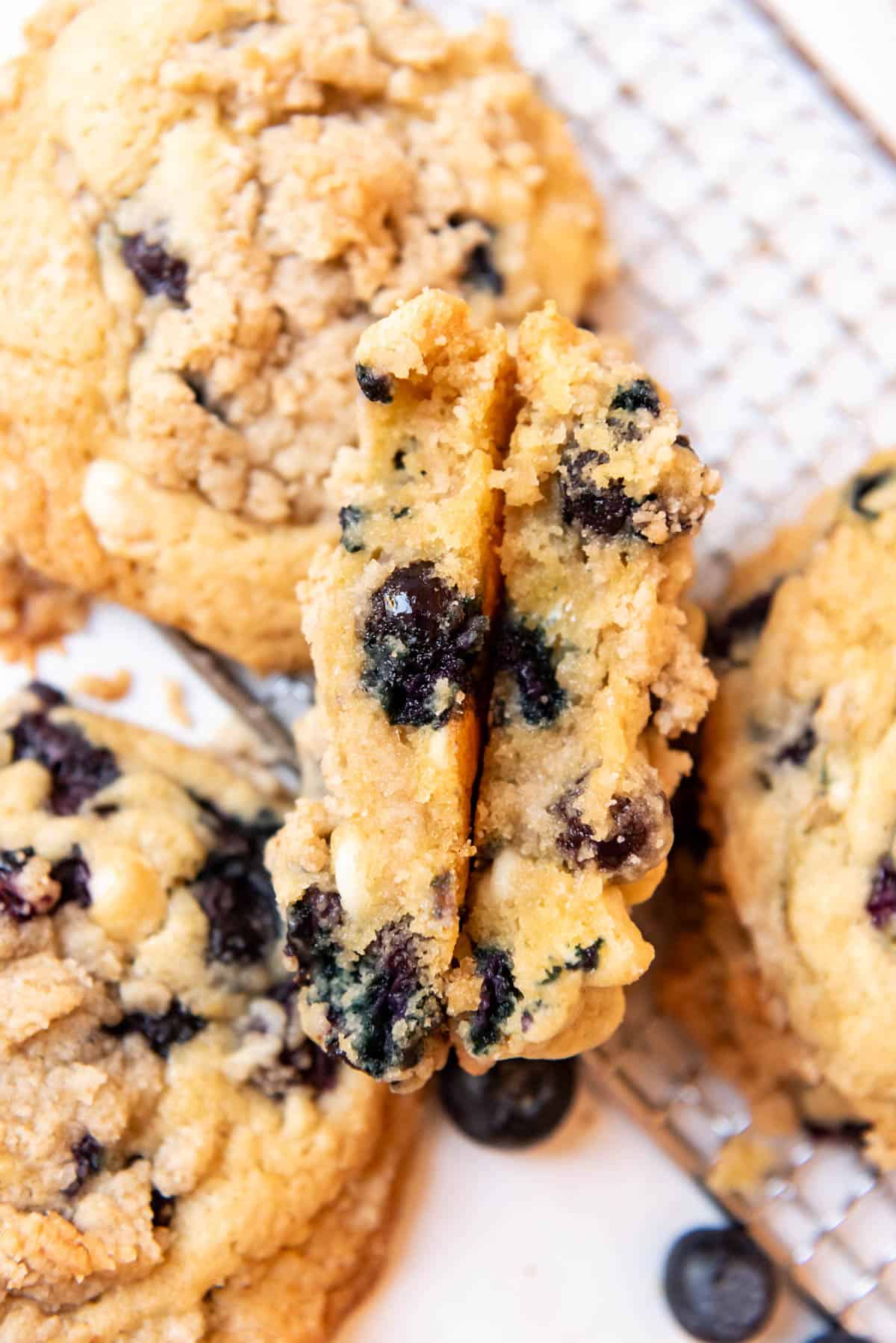 An overhead image of a blueberry muffin cookie that has been sliced in half.