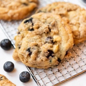 An image of blueberry muffin cookies on a wire cooling rack.