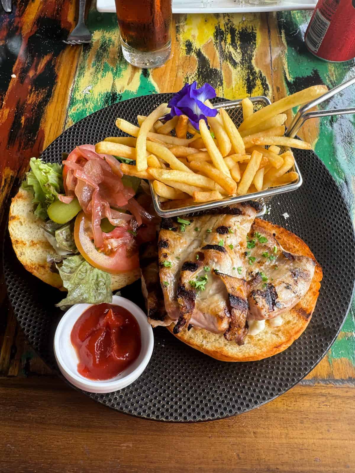 An image of a grilled fish sandwiches with fries at the Bora Bora Beach Club.