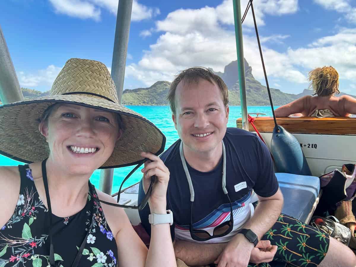 An image of a couple in swimsuits on a boating excursion in Bora Bora.