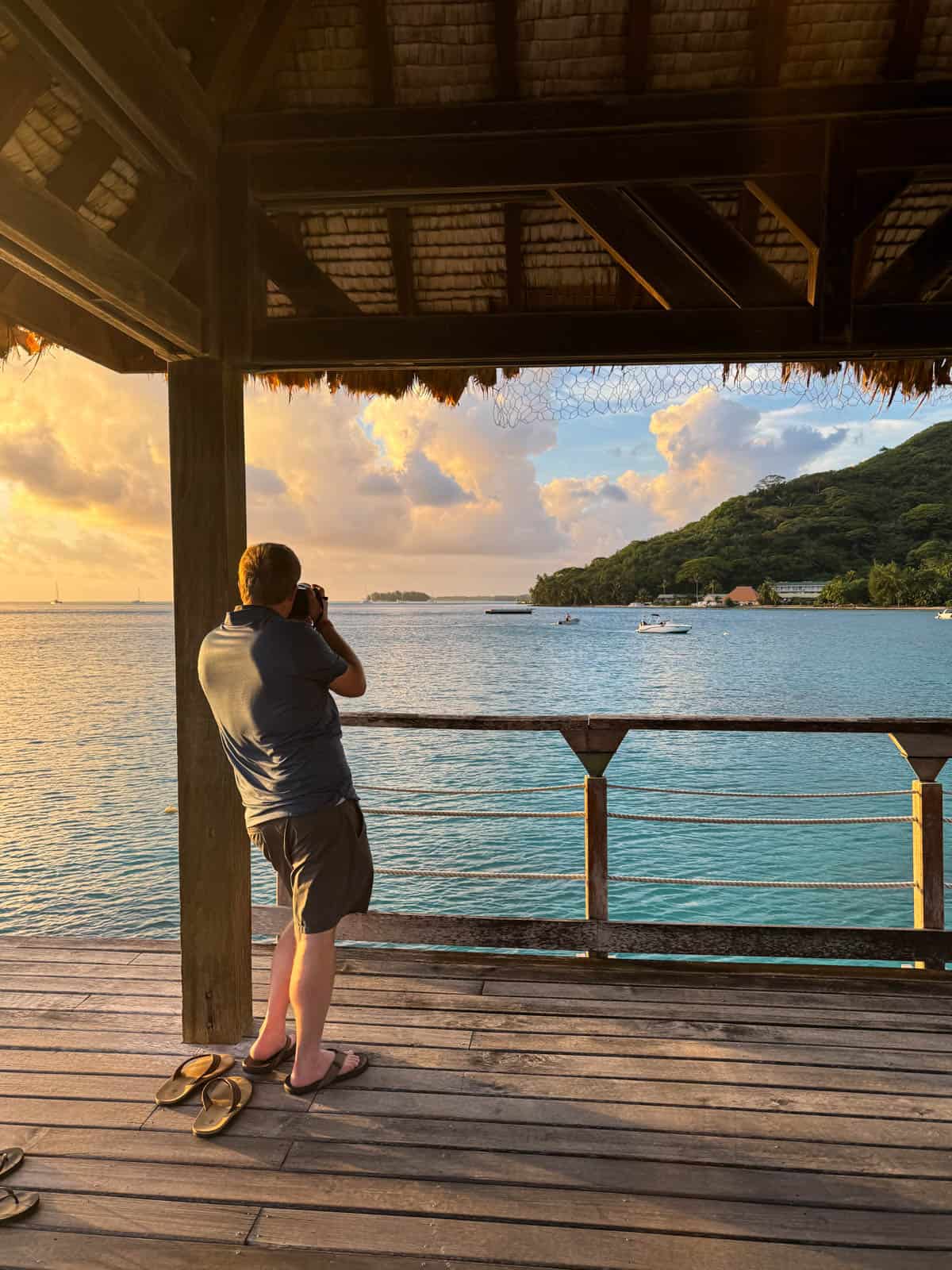 An image of a man taking photos at sunset.