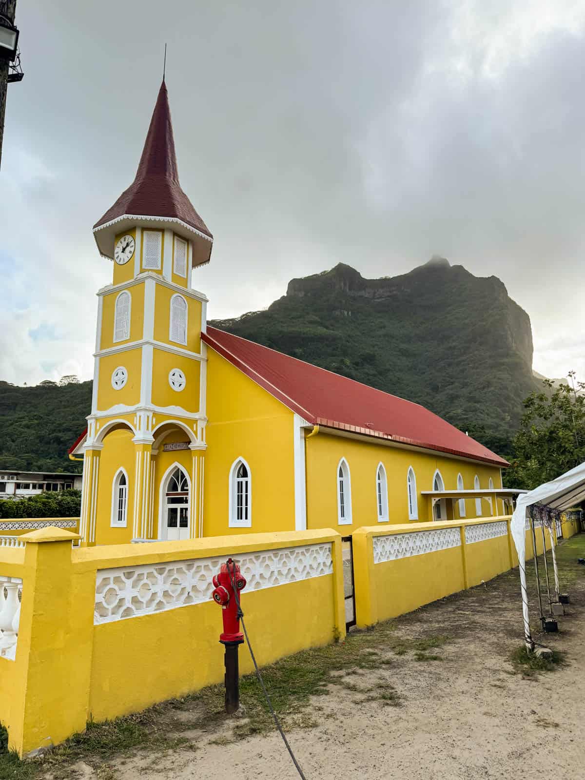 An image of a bright yellow church in Vaitape, Bora Bora.