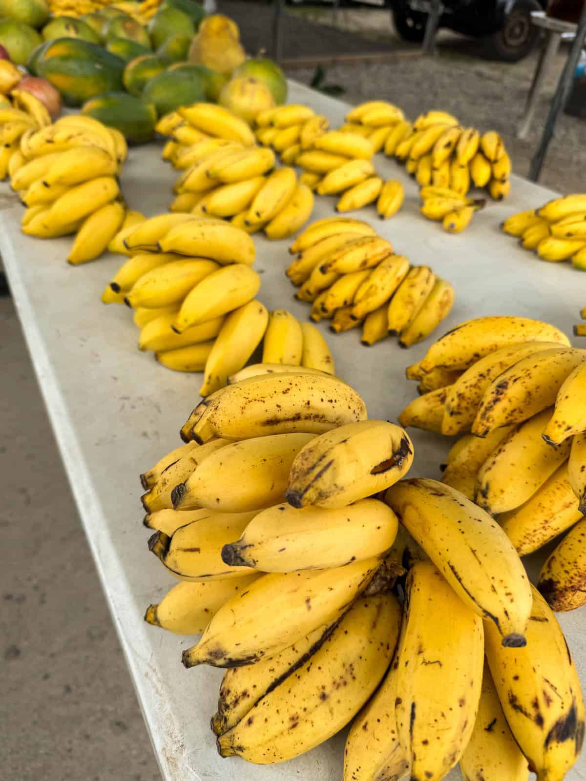 An image of bunches of small bananas on a table in French Polynesia.