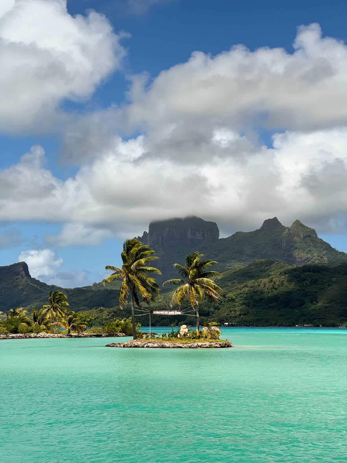 An image of the Bora Bora airport sign in a lagoon.