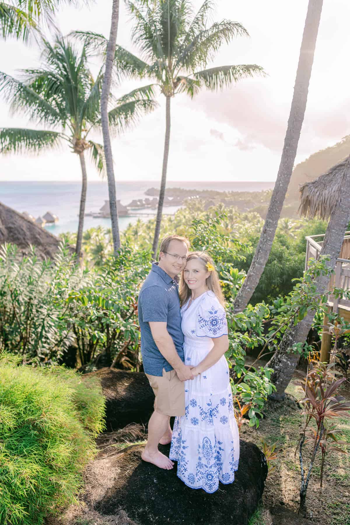 An image of a man and woman holding hands in a tropical setting in Bora Bora.