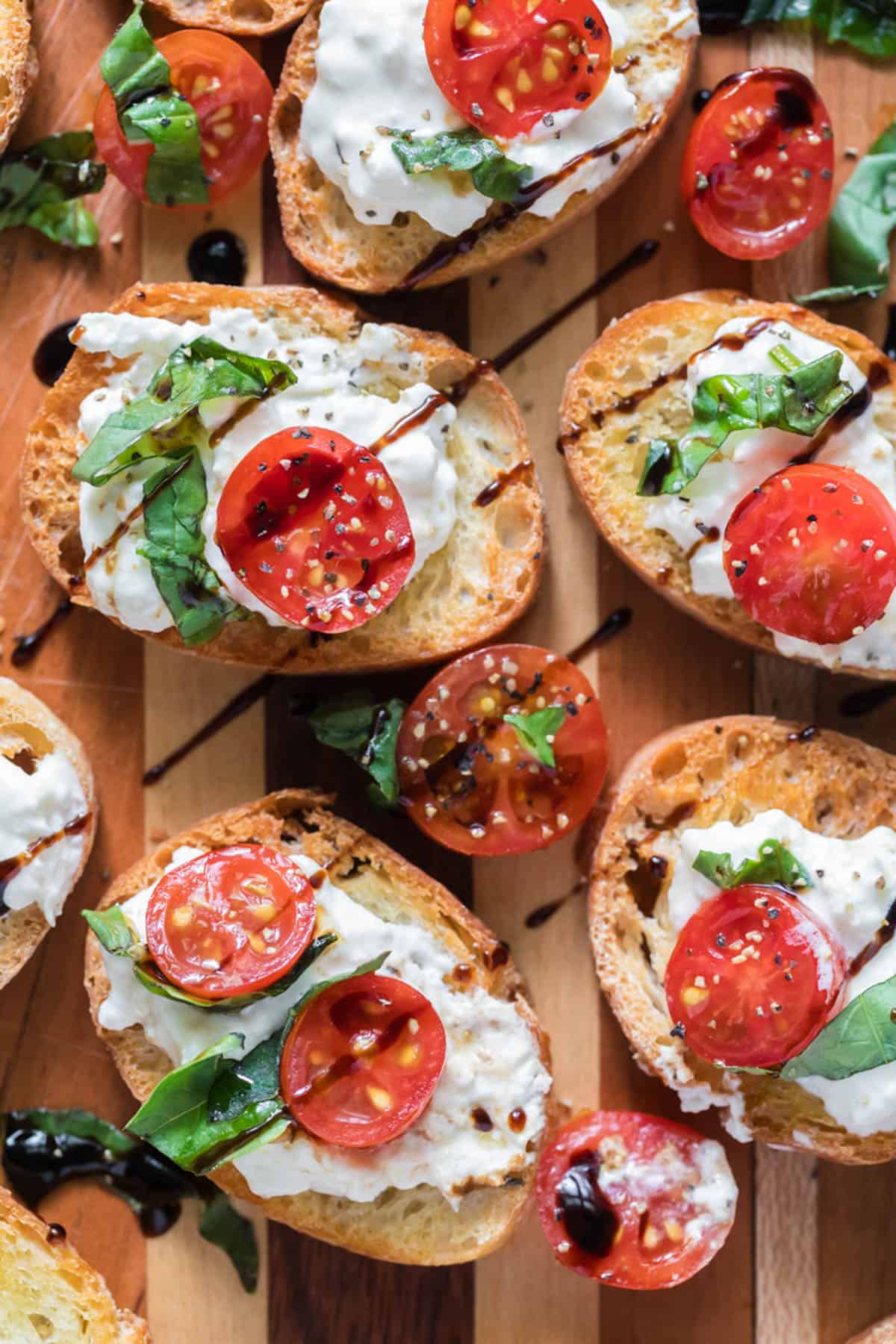 An overhead image of burrata caprese with balsamic glaze drizzled on top.