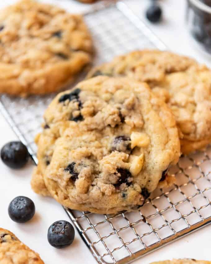 An image of blueberry muffin cookies on a wire cooling rack.