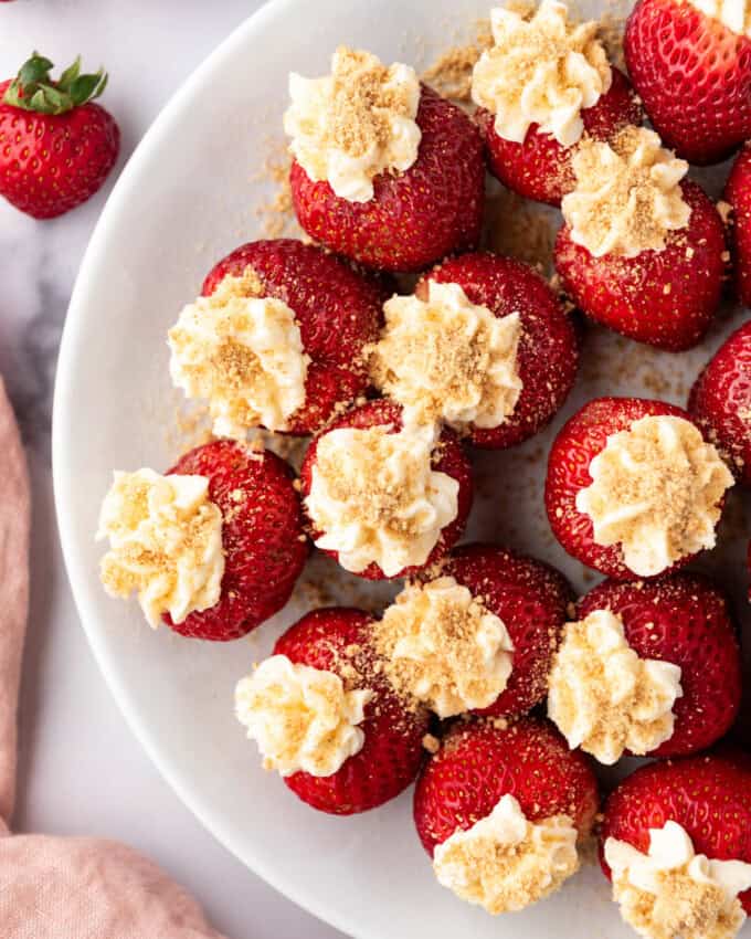 An overhead image of cheesecake stuffed strawberries.