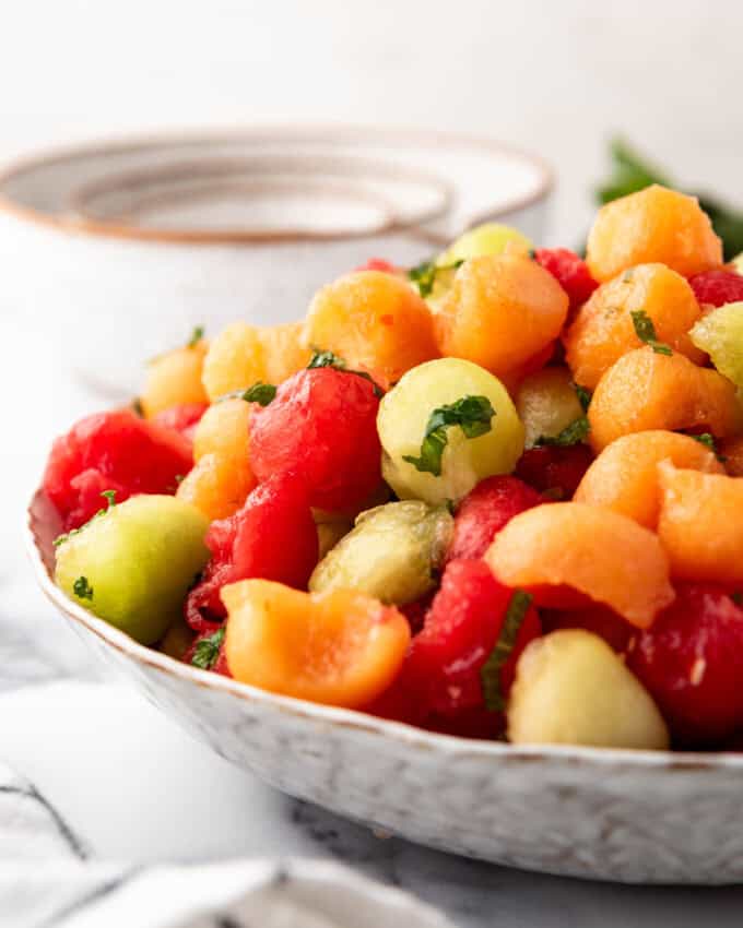 A side view of melon balls in a bowl.