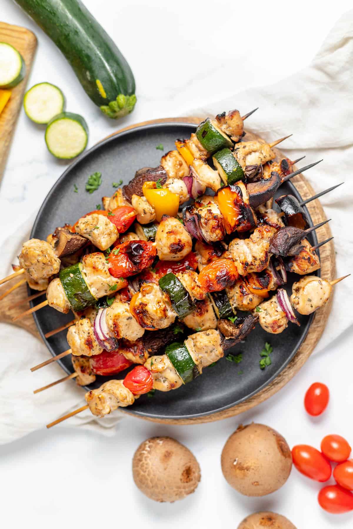 An image of grilled chicken and vegetable skewers.