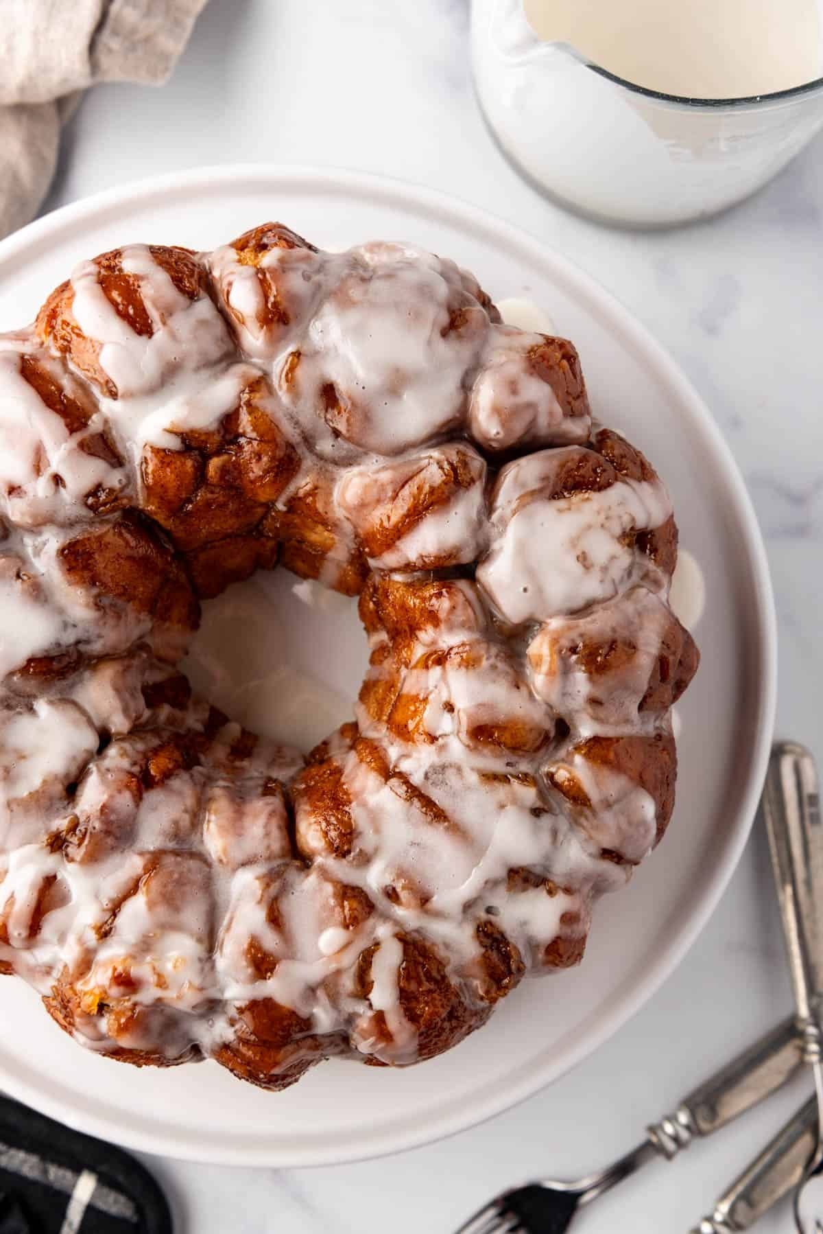 An overhead image of homemade monkey bread on a white plate.