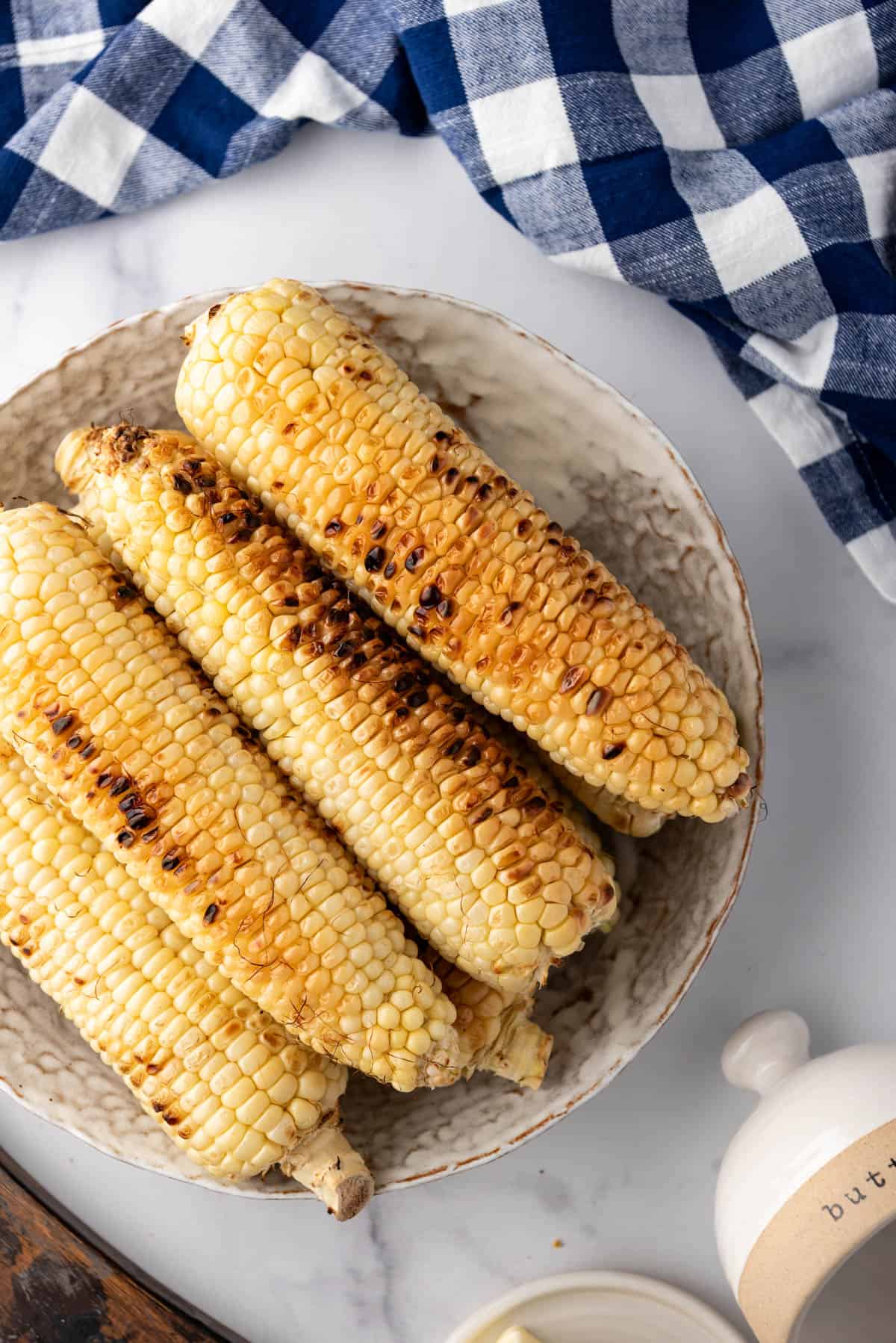 An overhead image of lightly charred grilled corn on the cob.