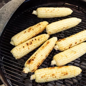 An image of shucked ears of corn on a charcoal grill.