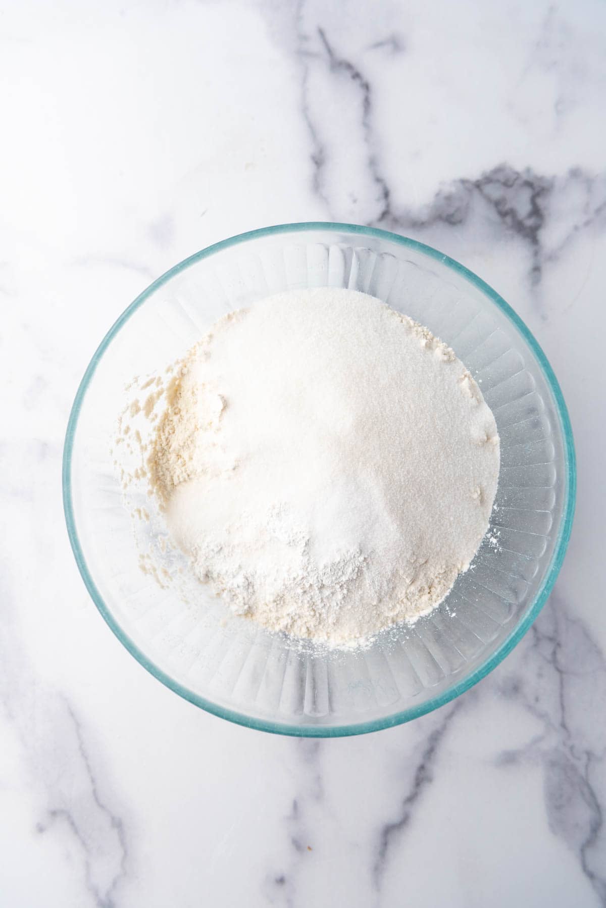 Combining dry ingredients in a mixing bowl.