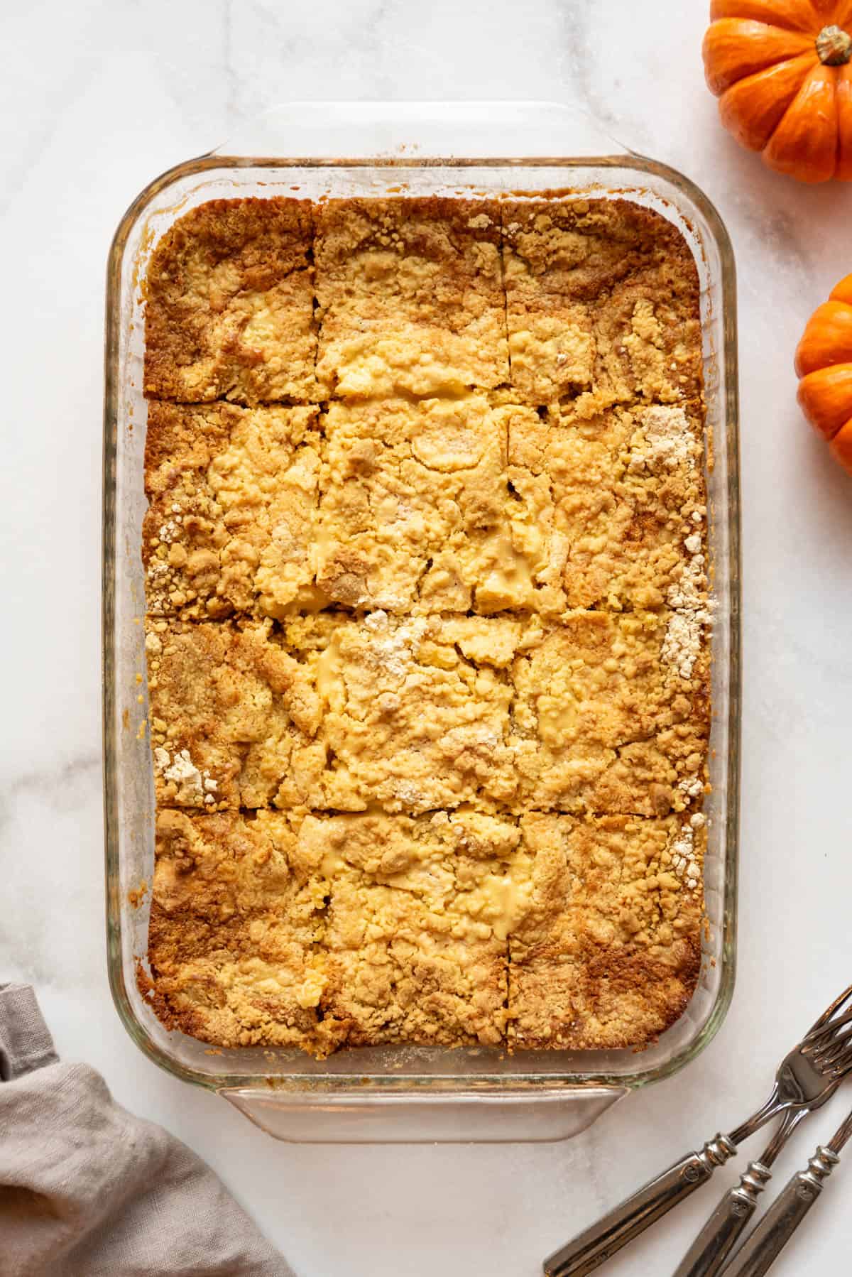 An overhead image of pumpkin dump cake cut into squares.