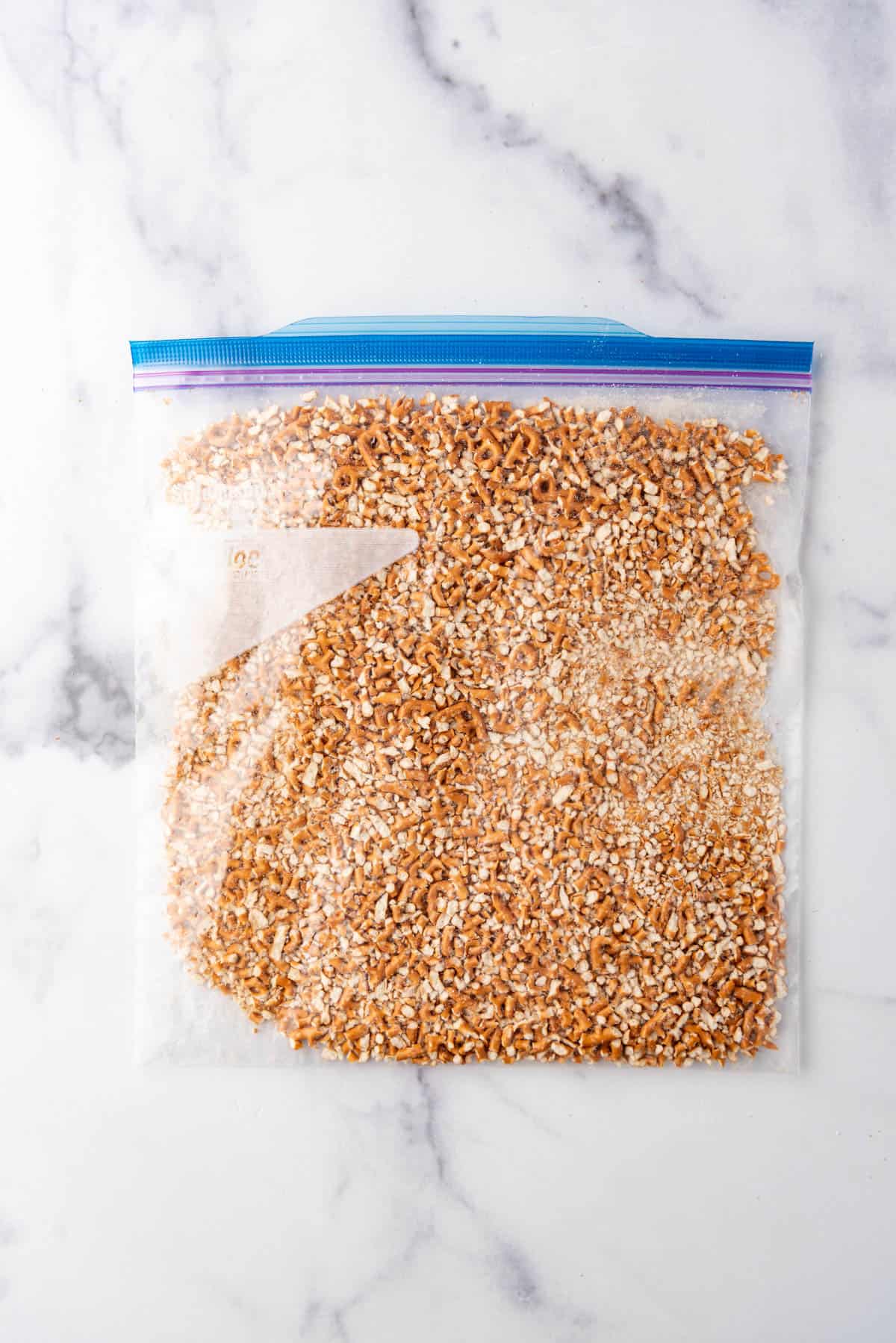 Crushed pretzels in a gallon-size ziploc bag.