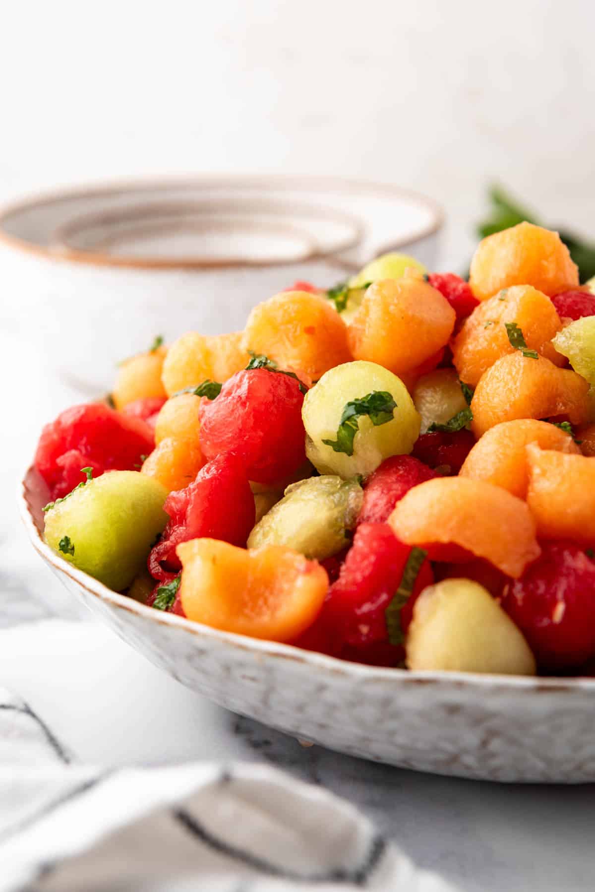 A side view of melon balls in a bowl.