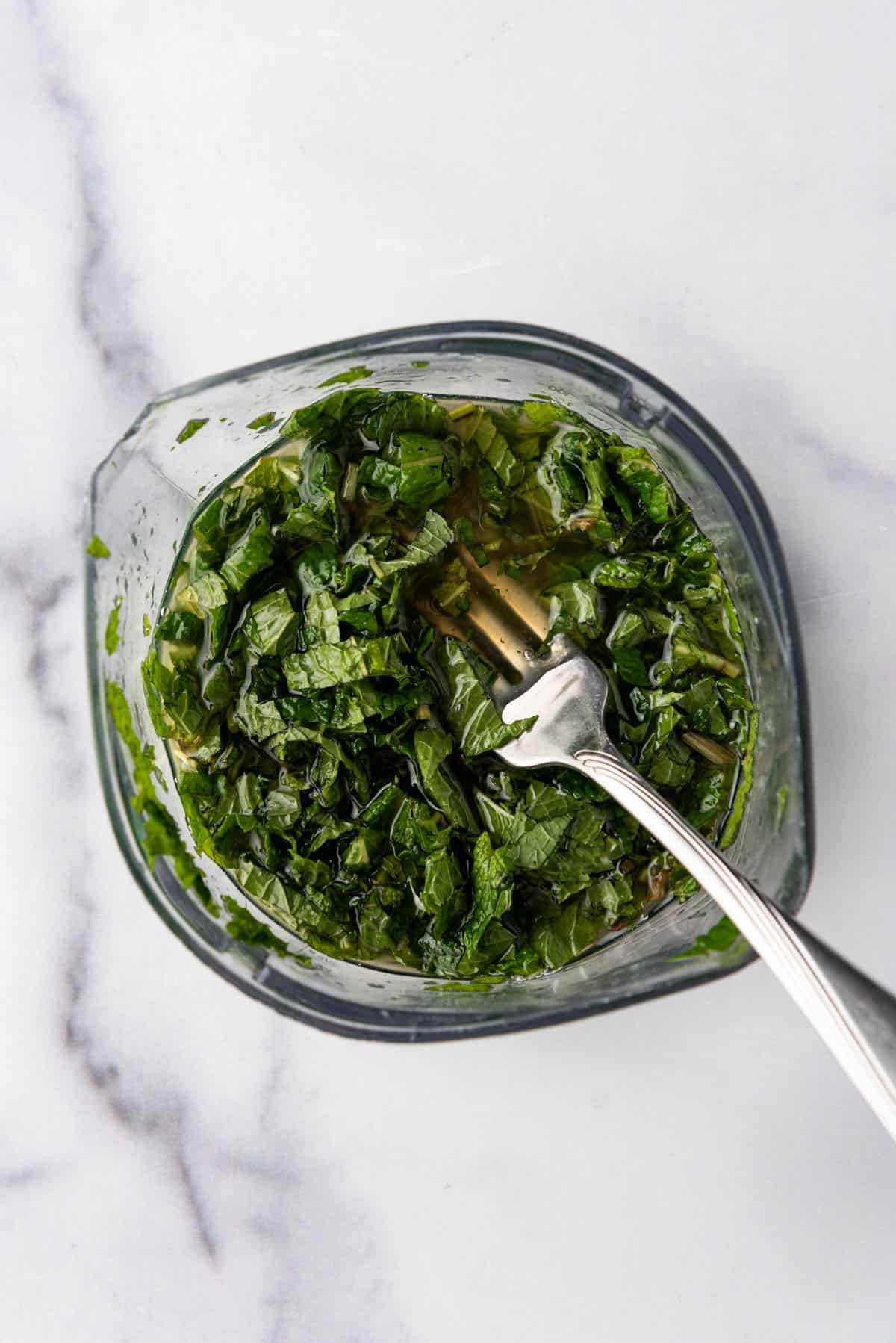 Combining honey, lemon juice, and chopped fresh mint in a small bowl.