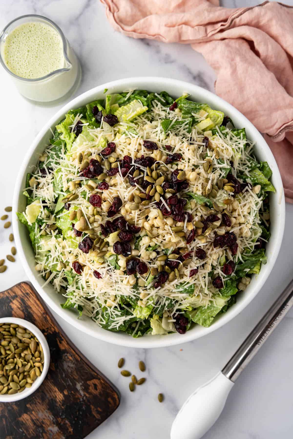 An overhead image of a large bowl of basil couscous salad.