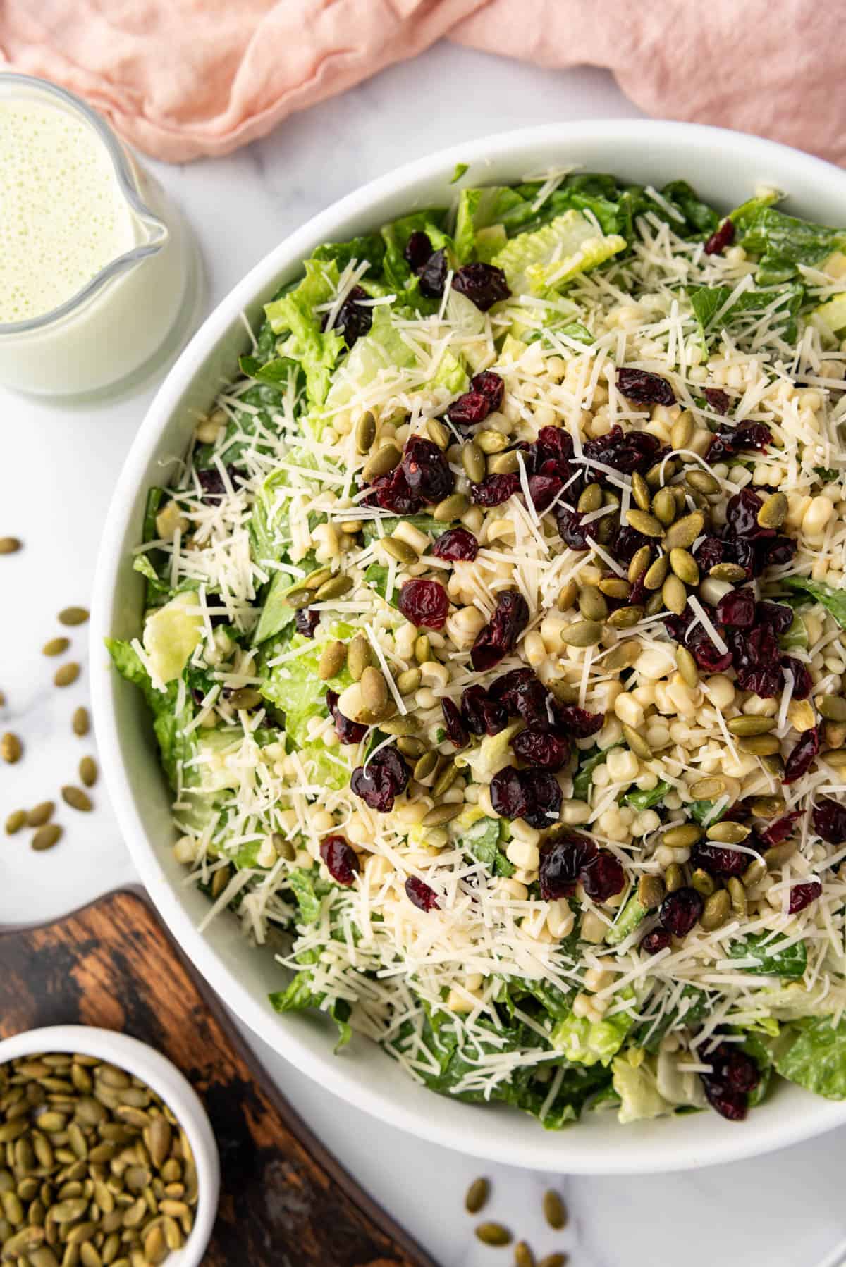 An overhead image of a large bowl of basil couscous salad.