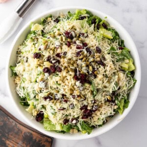 An overhead image of a large bowl of basil couscous salad.