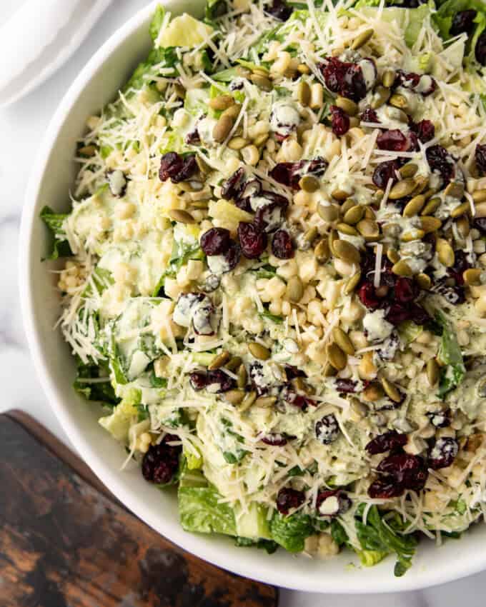 An overhead image of a large bowl of basil couscous salad.