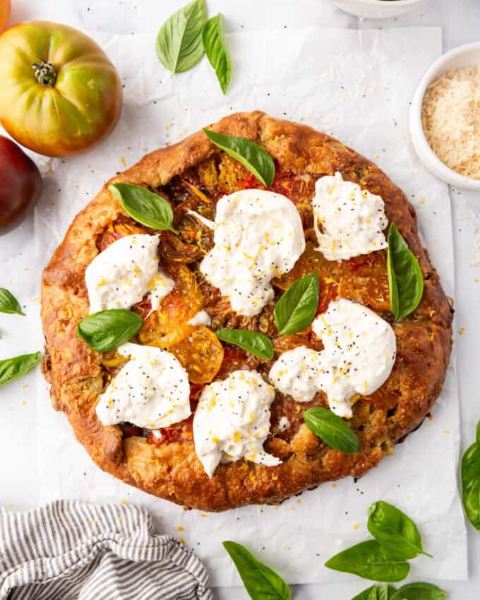 An image of an heirloom tomato galette with burrata cheese on top.