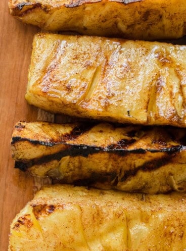 A close up overhead image of grilled pineapple spears.