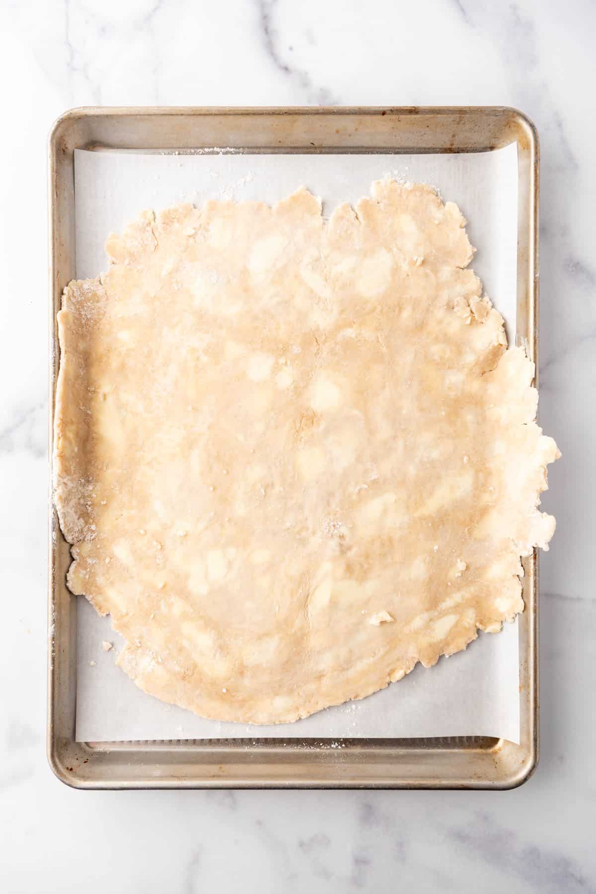 An image of a pie crust rolled out into a large circle.