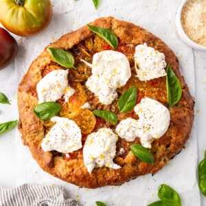 An image of an heirloom tomato galette with burrata cheese on top.