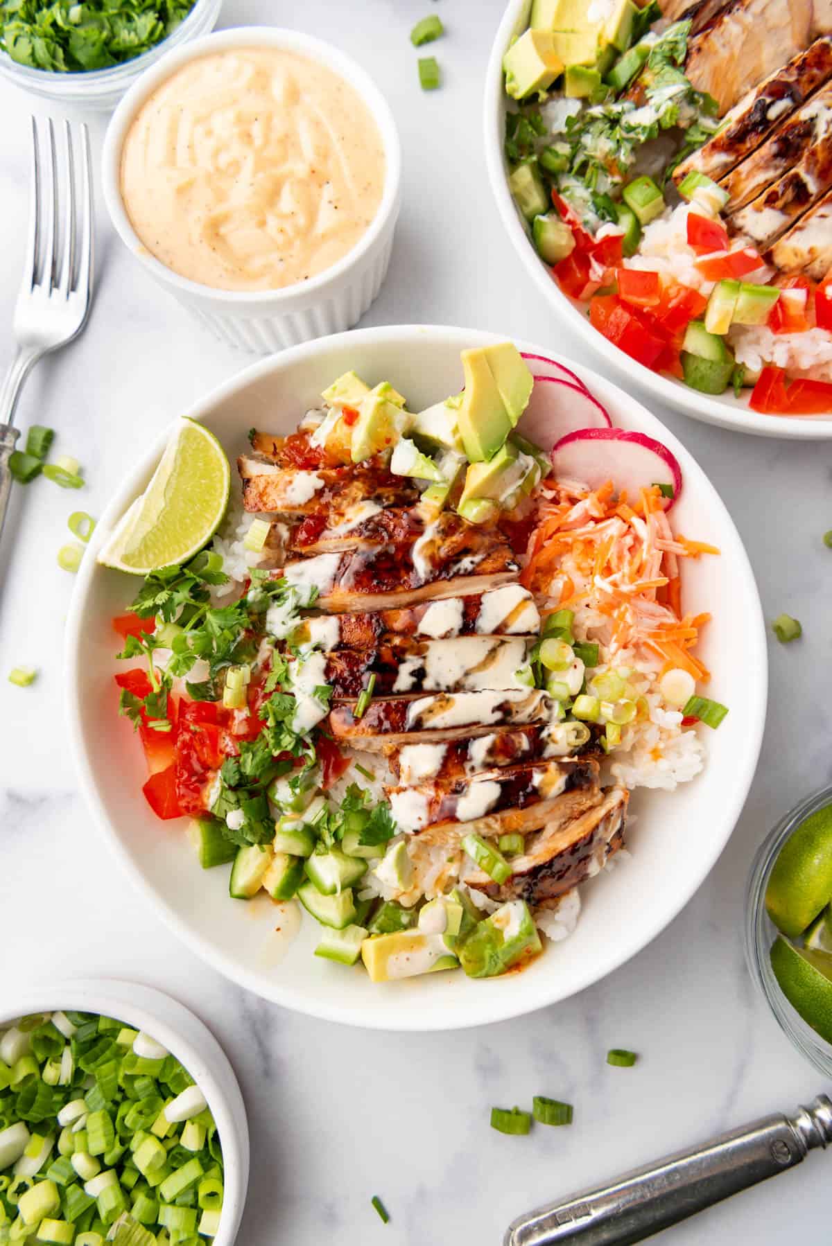 An overhead image of huli huli chicken and rice bowls.