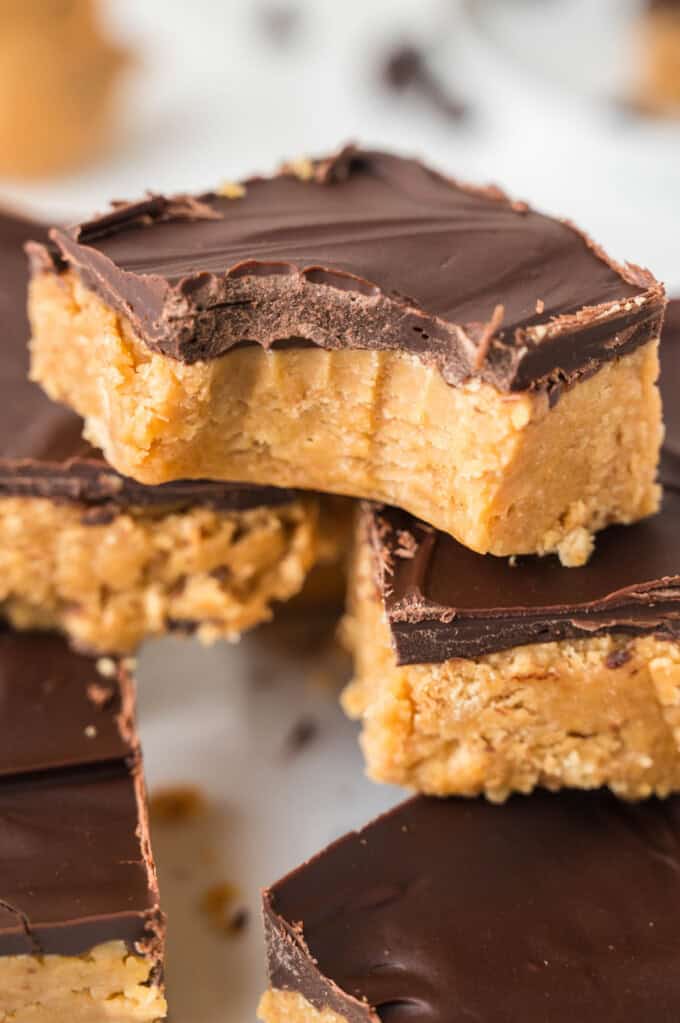 An image of a no-bake peanut butter square with a bite taken out of it.